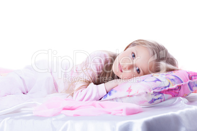 Little girl lying on bed