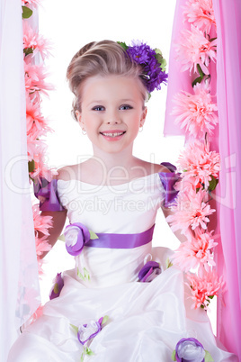 Beautiful little girl near pink flowers