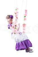 Beautiful child on floral swing isolated
