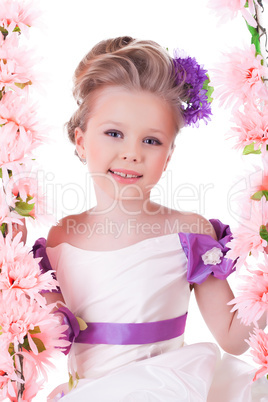 Pretty little girl near pink flowers