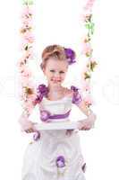 Pretty little girl near pink floral swing isolated
