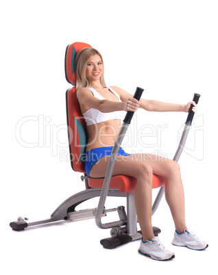 Blonde young woman on hydraulic exerciser