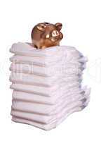 stack of diaper with golden piggybank