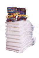 stack of diaper with baby shoes