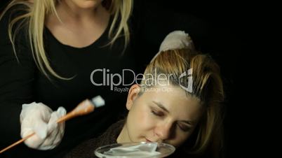 Hairdresser bleaching hair