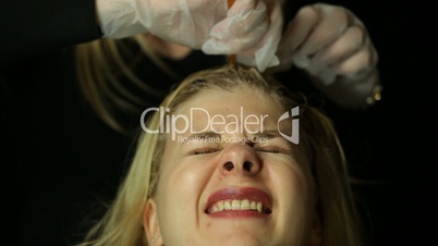Hairdresser bleaching hair
