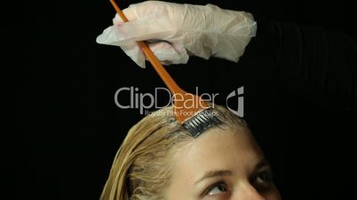 Hairdresser bleaching hair