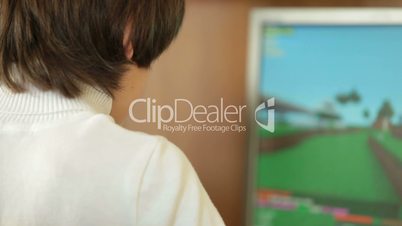 Child Playing Desktop Computer Games At Home
