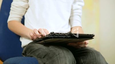 Child Using A Touch Screen Tablet PC
