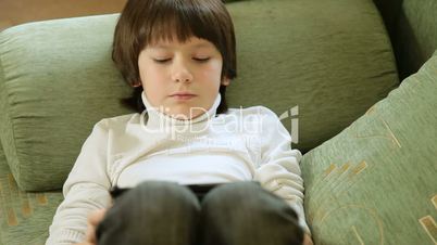 Child Playing Computer Games On Tablet Pc