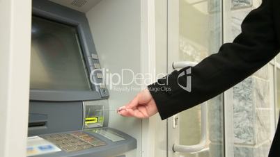 Woman Taking Money From ATM Machine