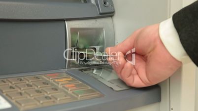 Businessman Using ATM Machine
