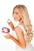Beautiful blonde woman holding a tub of ice cream
