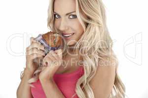 Beautiful woman eating a muffin