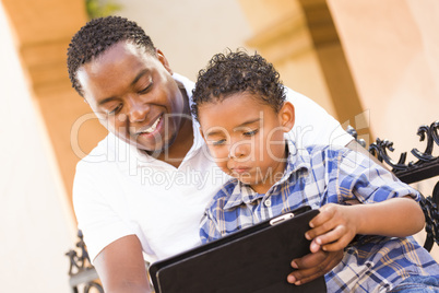 Mixed Race Father and Son Using Touch Pad Computer Tablet