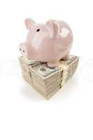 Pink Piggy Bank on Stacks of Money on White