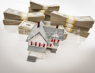 Stacks of Hundreds of Dollars with Small House