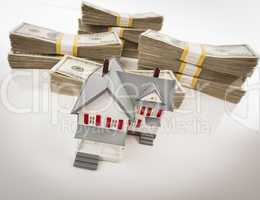 Stacks of Hundreds of Dollars with Small House