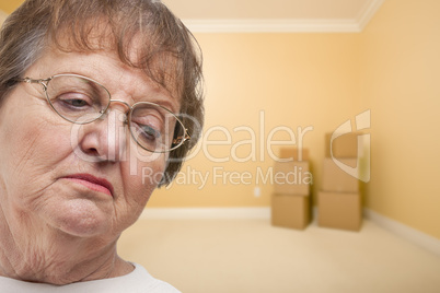 Sad Older Woman In Empty Room with Boxes