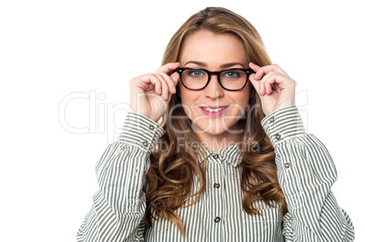 Smiling woman adjusting her spectacles