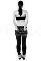 Back pose of a girl with hands in back pocket
