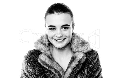 Smiling attractive girl in furry overcoat
