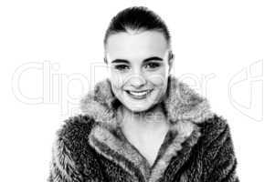 Smiling attractive girl in furry overcoat