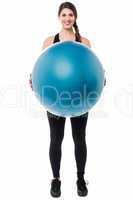 Gym girl presenting a swiss ball