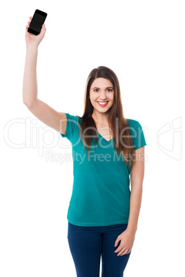 Beautiful young woman holding up a cell phone