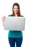 Cute young girl watching videos on laptop