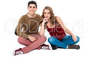 Adorable young lovers sitting on the floor