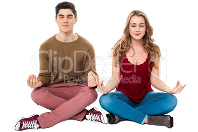 Friends meditating in lotus pose, peace of mind