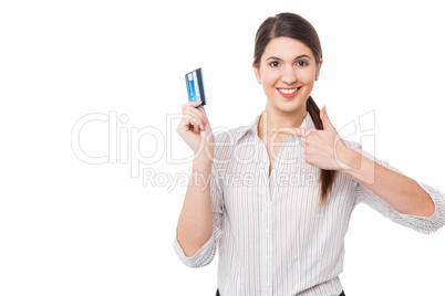 Smiling woman indicating towards credit card