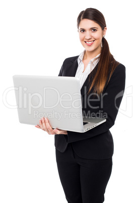 Young woman in formals posing with a laptop