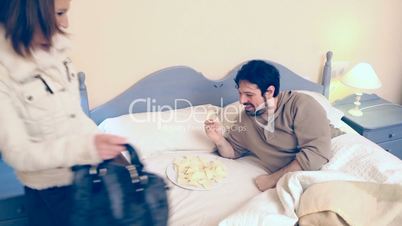 Man in bed and woman eat potato chips
