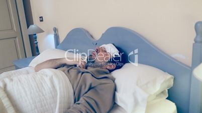 Man in bed measuring flu