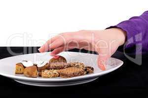 Woman's hand reaches for the cake plate