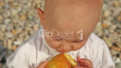 Baby eating apple - close up