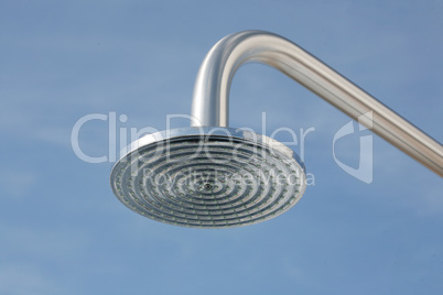 close up on head shower in a blue sky