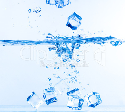 Ice Cubes Dropped into Water with Splash