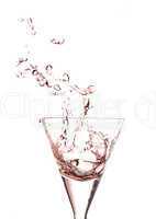 Splashing glass of red wine