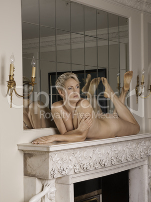 Woman on the fireplace without any clothes