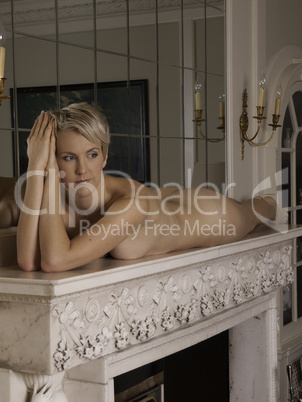 Woman on the fireplace without any clothes