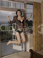 Woman in jacket, hat and lingerie jumping