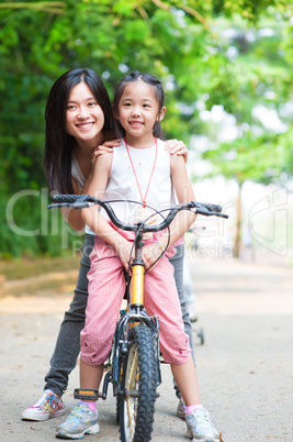 Asian family riding bike