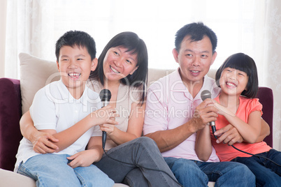 Asian family singing karaoke