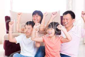 Asian family playing game at home.