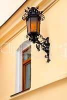 Old lamp with windows on wall
