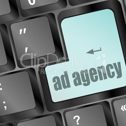 Advertising concept: computer keyboard with word Ad Agency, selected focus on enter button