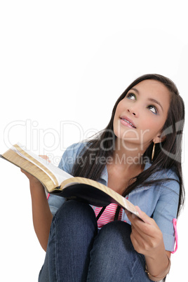 Beautiful young woman holding a Bible